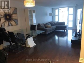 Toronto (Bay Street Corridor) condo for rent - A living room with a grey couch and a glass table.