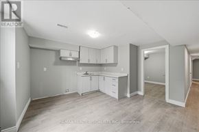 Bradford West Gwillimbury (Bradford) apartment for rent - A spacious kitchen with white cabinets and a large island.