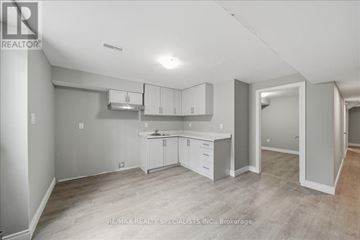 Bradford West Gwillimbury (Bradford) apartment for rent - A spacious kitchen with white cabinets and a large island.