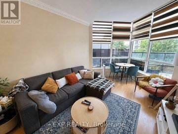 Toronto (Willowdale East) condo for rent - A living room with a grey couch and a coffee table.