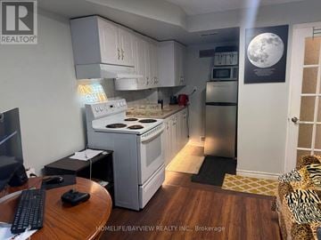 Markham (Thornhill) apartment for rent - A small kitchen with a stove and refrigerator.