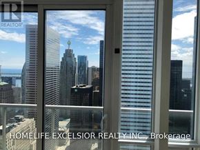 Toronto (Bay Street Corridor) condo for rent - A window with a view of a city skyline.