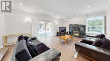 Markham (Bayview Glen) apartment for rent - A living room with a dark sofa and a wooden coffee table.