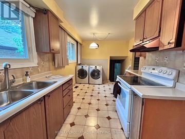 Richmond Hill (Crosby) apartment for rent - A kitchen with a white stove top oven and a white sink.