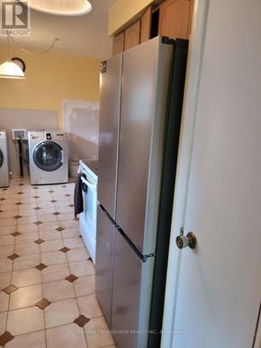 Richmond Hill (Crosby) apartment for rent - A kitchen with a white fridge and a tiled floor.