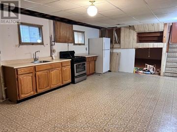 Richmond Hill (Crosby) apartment for rent - A kitchen with wooden cabinets and a patterned floor.