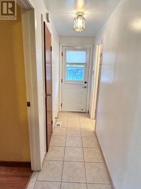 Richmond Hill (Crosby) apartment for rent - A hallway with a white door and tiled floor.