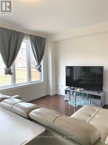 Markham (Cedarwood) apartment for rent - A living room with a white couch and a flat screen TV.