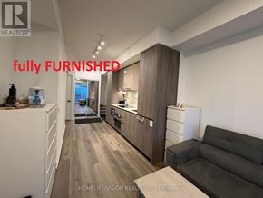 Vaughan (Vaughan Corporate Centre) condo for rent - A fully furnished kitchen and living room with a couch and a coffee table.