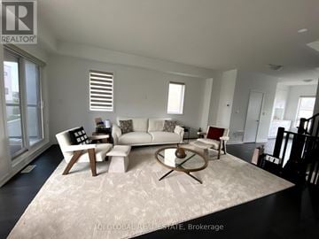 Burlington (Alton) townhouse for rent - A living room with a white couch and a coffee table.