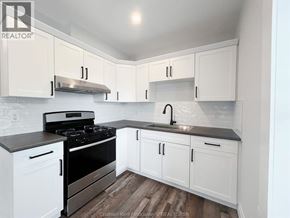 Chatham apartment for rent - A kitchen with white cabinets and a black stove top.