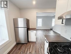Chatham apartment for rent - A kitchen with a stainless steel refrigerator and a stove top oven.