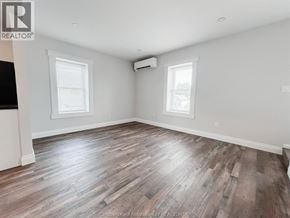 Chatham apartment for rent - A room with wooden flooring and two windows.