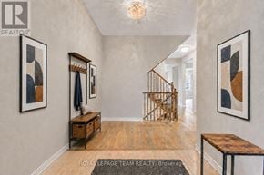 Ottawa apartment for rent - A hallway with a wooden bench and a painting on the wall.