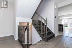 Ottawa apartment for rent - A staircase with a wooden handrail and a light on it.