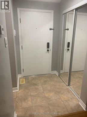 Russell condo for rent - A bathroom with a tiled floor and a white door.