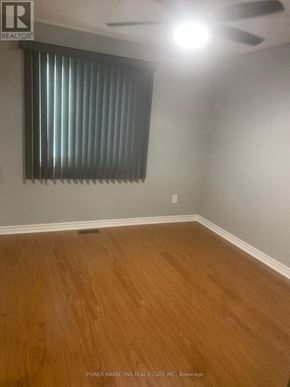Russell condo for rent - A room with wooden flooring and a window with blinds.