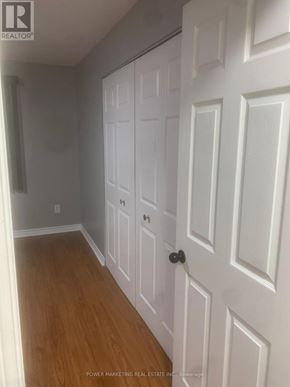 Russell condo for rent - A white door with a black handle is in a room with wooden floors.