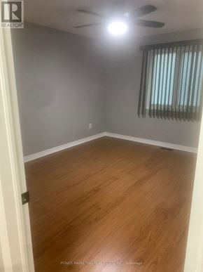 Russell condo for rent - A room with wooden flooring and a ceiling fan.