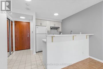 Toronto (Waterfront Communities) condo for rent - A kitchen with white cabinets and a white counter.