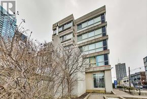 Toronto (Mount Pleasant West) townhouse for rent - A modern building with a glass facade stands tall among other buildings.