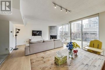 Toronto (Mount Pleasant West) townhouse for rent - A living room with a white couch and a yellow chair.
