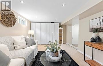Oshawa (Centennial) apartment for rent - A modern living room with a white sofa and a wooden coffee table.
