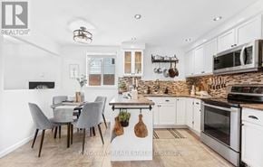 Oshawa (Centennial) apartment for rent - A kitchen with a table and chairs in the middle of the room.