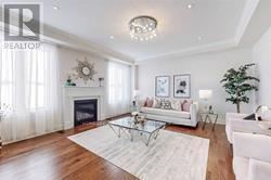 East Gwillimbury (Queensville) apartment for rent - A living room with a fireplace and a glass coffee table.