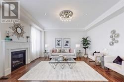 East Gwillimbury (Queensville) apartment for rent - A living room with a fireplace and a white couch.