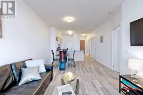 Vaughan (Beverley Glen) condo for rent - A living room with a black couch and a wooden coffee table.