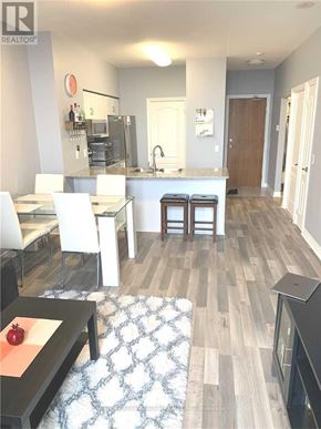 Vaughan (Beverley Glen) condo for rent - A modern kitchen with white chairs and a wooden floor.