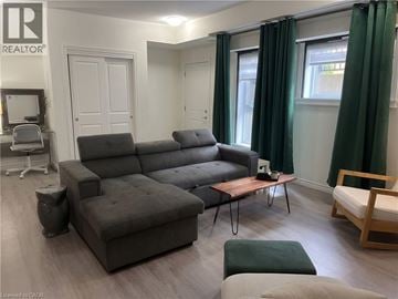 Cambridge townhouse for rent - A grey sofa in a living room with a wooden coffee table.