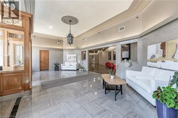 Kitchener condo for rent - A living room with a white couch and a wooden coffee table.
