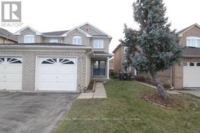 Mississauga (Lisgar) apartment for rent - A house with a grey garage door is for sale.