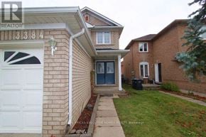 Mississauga (Lisgar) apartment for rent - A house with a white garage door and a brick wall.