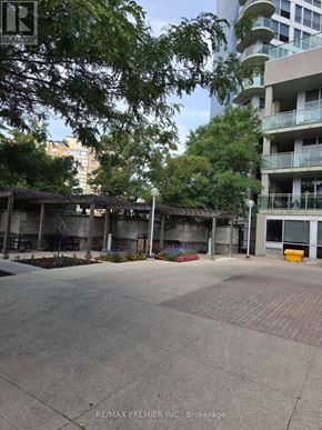 Toronto (Keelesdale-Eglinton West) condo for rent - A large open area in front of a building with a tree in the foreground.