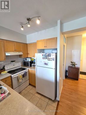 Toronto (Keelesdale-Eglinton West) condo for rent - A kitchen with a refrigerator, oven, and microwave.