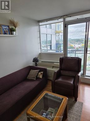 Toronto (Keelesdale-Eglinton West) condo for rent - A living room with a couch, chair, and coffee table.