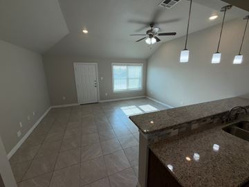 Temple townhouse for rent - A kitchen with a counter and a fan.