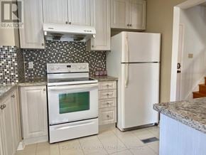 Markham (Markville) apartment for rent - A kitchen with white appliances and cabinets.