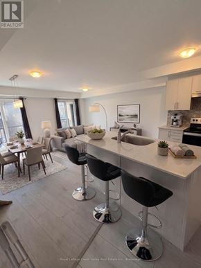 Barrie townhouse for rent - A modern kitchen with a bar stool in front of the island.