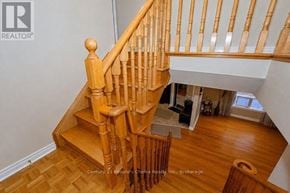 Mississauga (Meadowvale Village) apartment for rent - A wooden staircase with a white wall in the background.