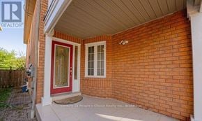 Mississauga (Meadowvale Village) apartment for rent - A red door is on the left side of a brick house.