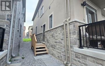 Clarington (Newcastle) apartment for rent - A narrow alley with stone walls and a wooden staircase.