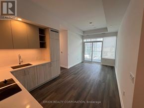 Vaughan (Vaughan Corporate Centre) condo for rent - A kitchen with wooden cabinets and a sink.
