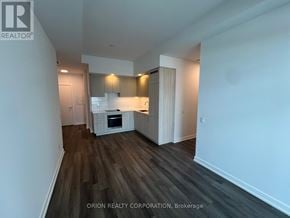 Vaughan (Vaughan Corporate Centre) condo for rent - A spacious room with wood flooring and white walls.