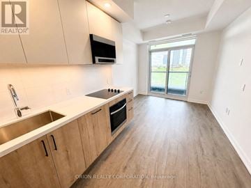 Vaughan (Vaughan Corporate Centre) condo for rent - A kitchen with wooden cabinets and a stainless steel sink.