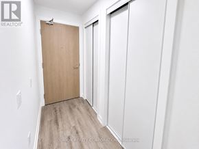 Vaughan (Vaughan Corporate Centre) condo for rent - A room with a wooden door and white walls.