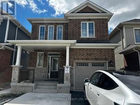 Milton (Cb Cobban) apartment for rent - A two-story brick house with a white garage door and a car parked in front.